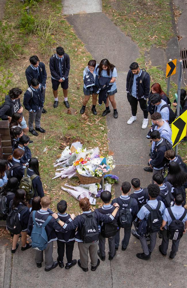 Students from Carlingford High School lay flowers at the scene of the crash. Picture: Julian Andrews