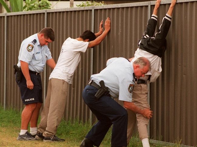 Police search suspects following a shooting at the Kookaburra Hotel in Canley Vale in March 2000. Picture: Troy Bendeich 