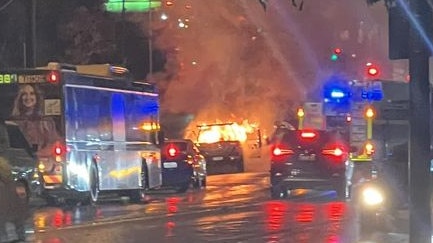 Car fire causing traffic delays along Musgrave Rd in Red Hill on Monday night. Photo: Laura Hannah