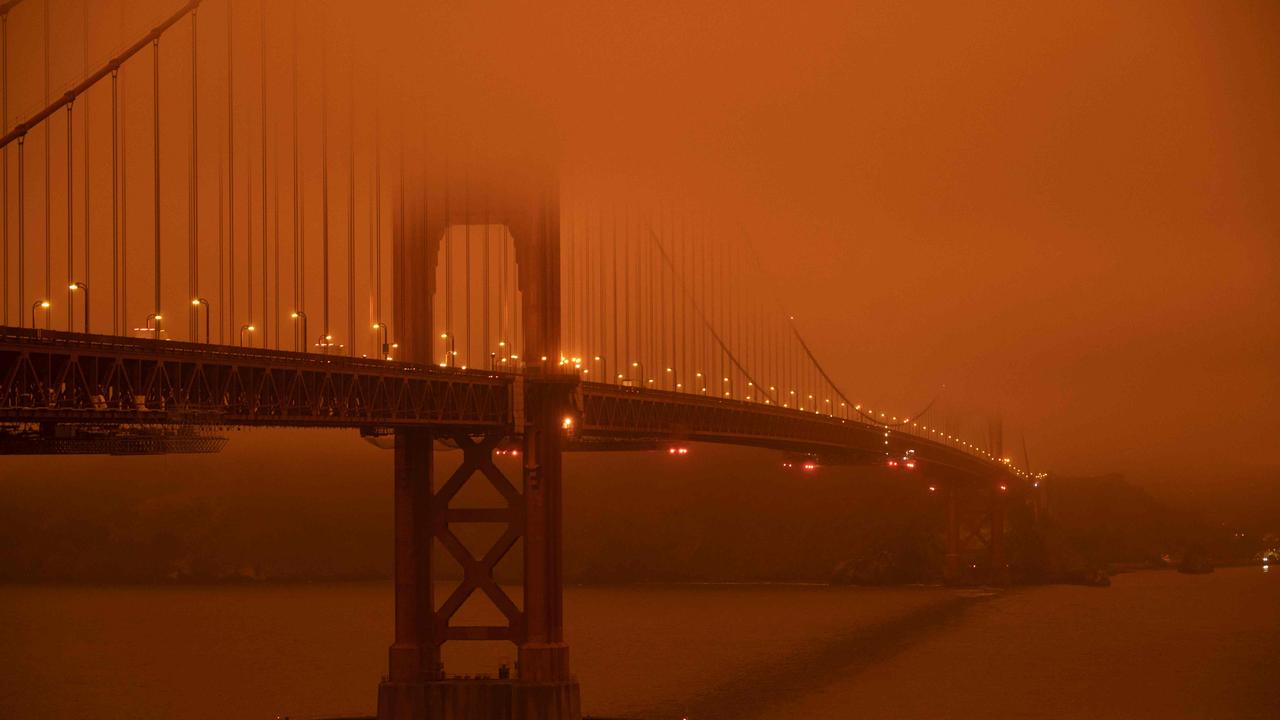 The Golden Gate Bridge in San Francisco, shrouded in orange smoke. This photo was taken at midday. Picture: Harold Postic/AFP