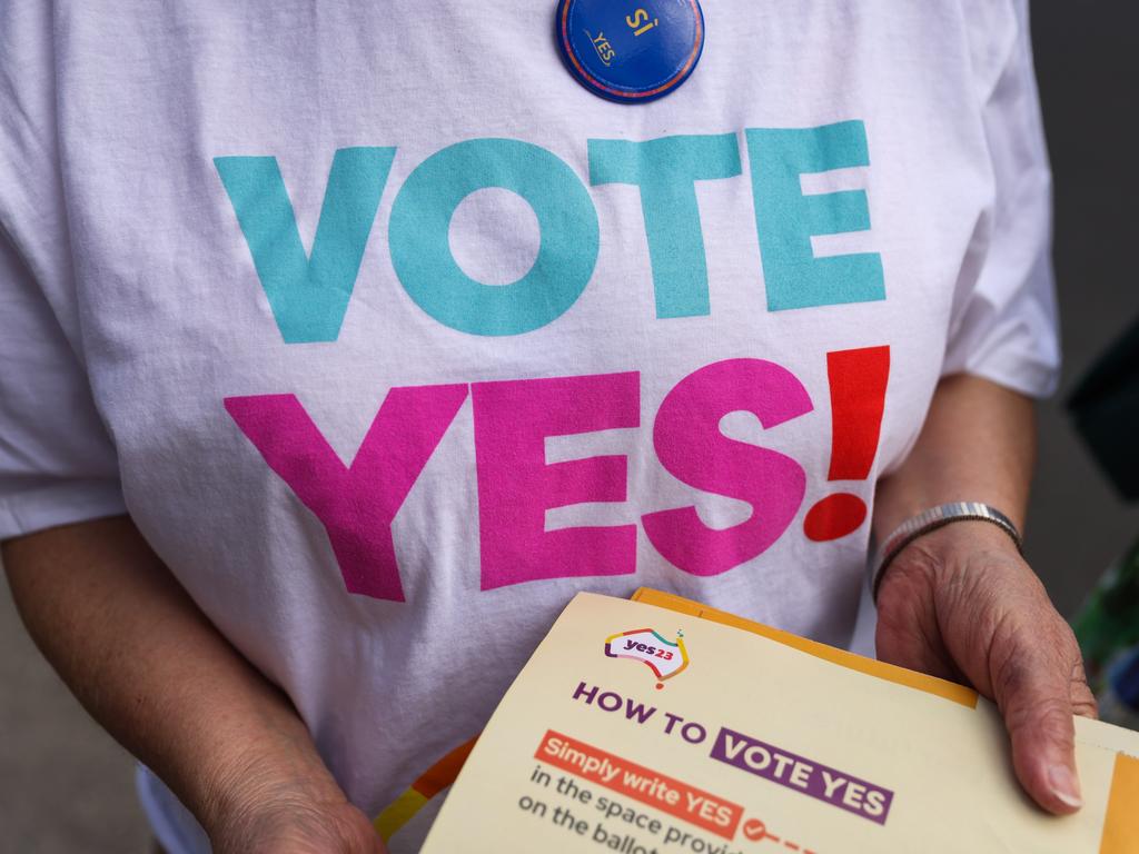 A volunteer hands out how-to-vote cards. Picture: Asanka Ratnayake/Getty Images