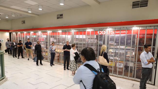 Customers queue outside Coles at Wynyard Station in Sydney in March. Picture: David Swift.