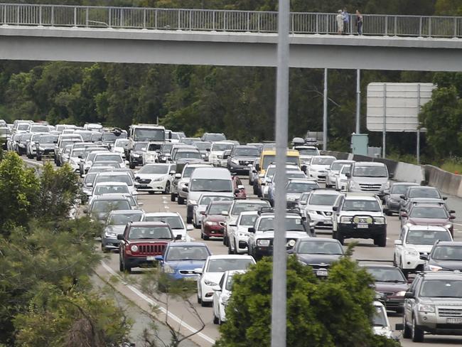 Slow moving traffic along the M1 near Oxenford, Gold Coast, Saturday, January 18, 2020. The M1 was closed for several hours in the morning due to flash flooding at Exit 57 after a severe thunder storm swept the Coast during the early hours of the day dumping 128mm of rain in an hour. (AAP Image/Regi Varghese)