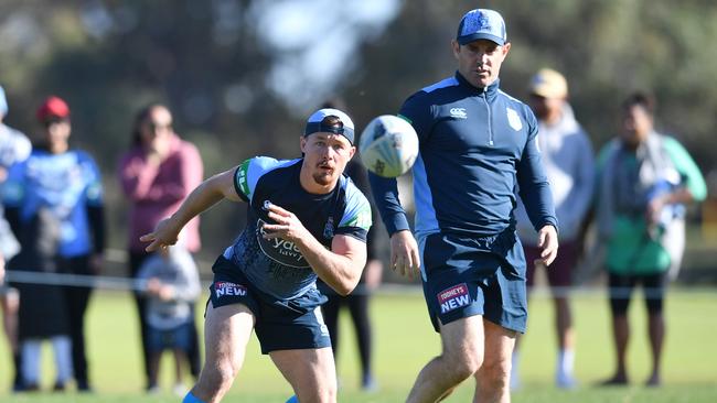 Damien Cook trains with a wet ball as coach Brad Fittler looks on. Picture: AAP Image/Darren England