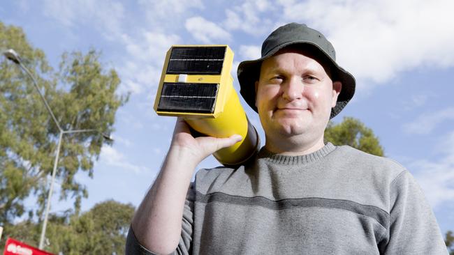 Griffith University’s Dr Jarrod Trevathan tests the water on Lake Ellerslie using the locally designed and manufactured SEMAT system which Logan City Council has supported. (AAP Image/Renae Droop)