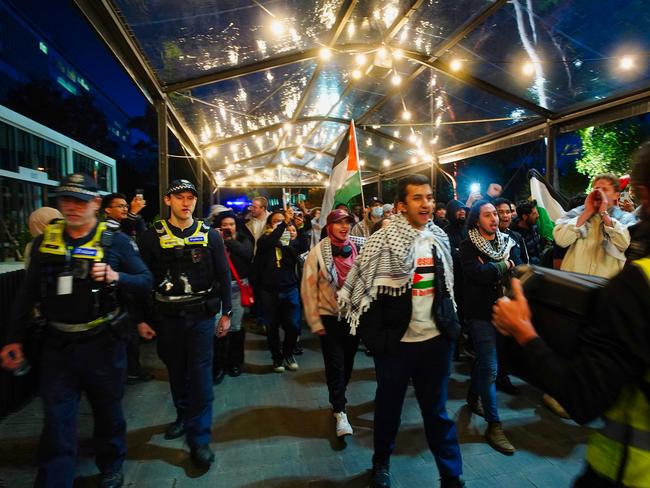 Protesters march through the grounds of Monash University. Picture: Luis Enrique Ascui