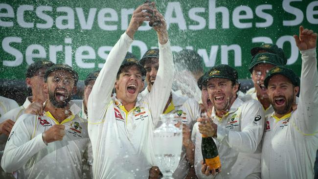 Australia's captain Tim Paine (C) lifts the Ashes Urn aloft during the presentation ceremony on the fourth day of the fifth Ashes cricket Test in 2019. – England won the fifth test and drew the series but Australia retained The Ashes Urn. Picture: Daniel Leal-Olivas/AFP)