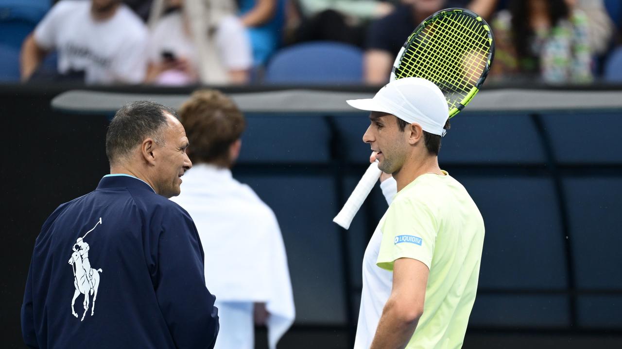 Vukic talks with the umpire as play was suspended. (Photo by Hannah Peters/Getty Images)