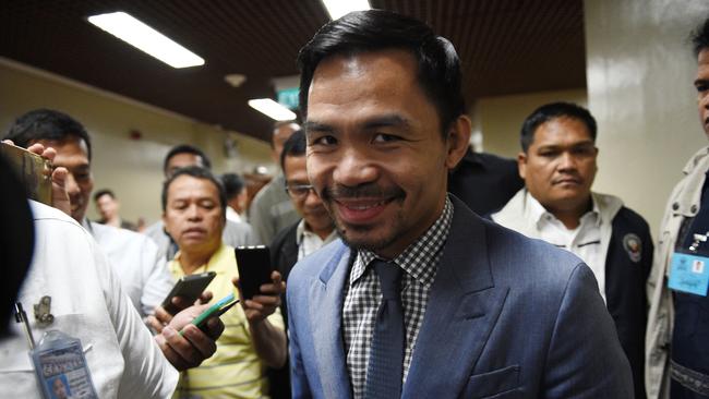 Filipino boxing icon Manny Pacquiao arrives for a senate session in Manila.