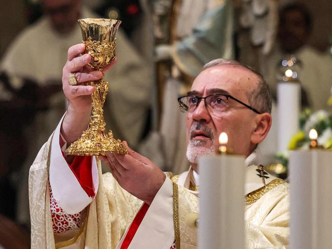 Latin Patriarch of Jerusalem Pierbattista Pizzaballa prepares communion during the Christmas midnight Mass at the Catholic Church of Saint Catherine, in the Nativity Church Complex, in the biblical city of Bethlehem. Picture: AFP