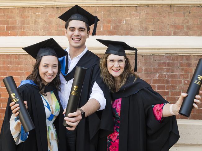 Bachelor of Nursing graduates Louise McDonald (right) with her daughter Sophie Edser and son-in-law Ryley Edser at the UniSQ graduation ceremony at Empire Theatres, Tuesday, October 31, 2023. Picture: Kevin Farmer