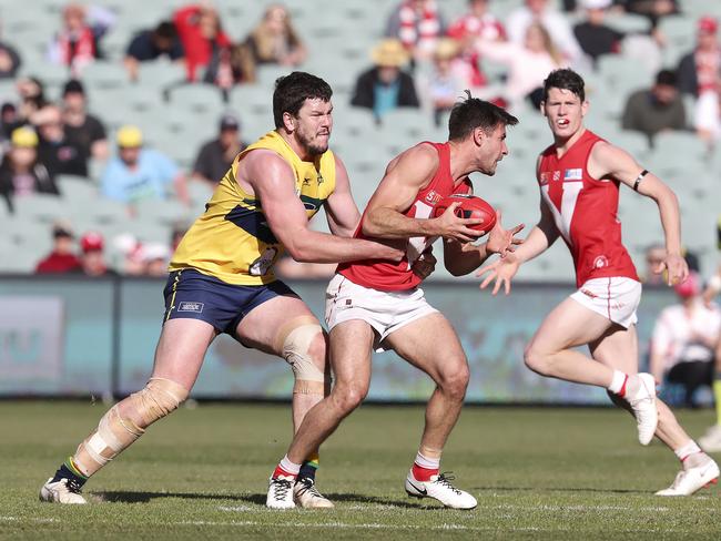 Eagles ruckman Jarrad Redden tries to wrap up North’s Aidan Tropiano. Picture: Sarah Reed