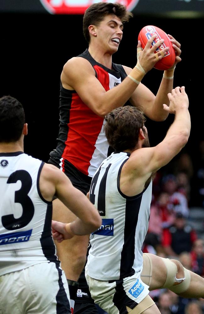 St Kilda youngster Lewis Pierce marks over Levi Casboult. Picture: George Salpigtidis