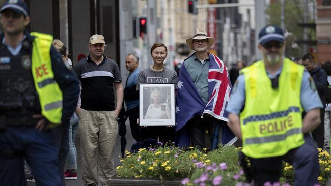 Pro-monarchy demonstrators Dana Pham (centre) and Kim Jacobs (right) brave the crowd of activists at Sydney’s Town Hall Thursday.