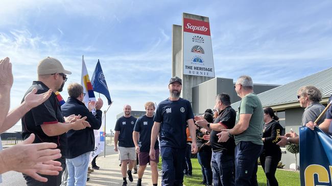 Saputo Dairy Australia Burnie factory workers walking off the site as a guard of honour is formed by union members. Picture: Simon McGuire.