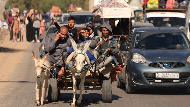 A Gazan family flees by donkey cart on Saturday. Picture: AFP