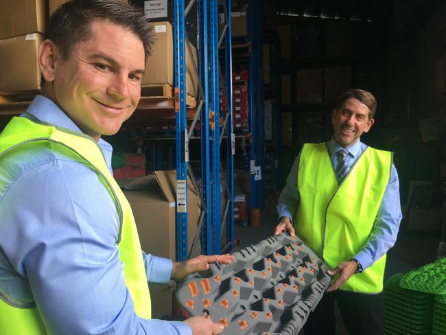 Evolve’s Ben Petersen with Innovation Minister Cameron Dick with some plastic treads.