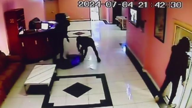 Two men can be seen punching and kicking the business owner in the head. Picture: 9 News