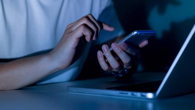 The Indonesian-Australian man saved dozens of intimate images of the woman on his electronic devices. Generic image of man using electronic devices.