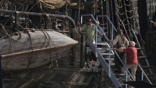 Hollywood superstar Johnny Depp, surrounded by bodyguards, climbs aboard the Pirates of the Caribbean 5 set at The Spit. Picture: Regi Varghese