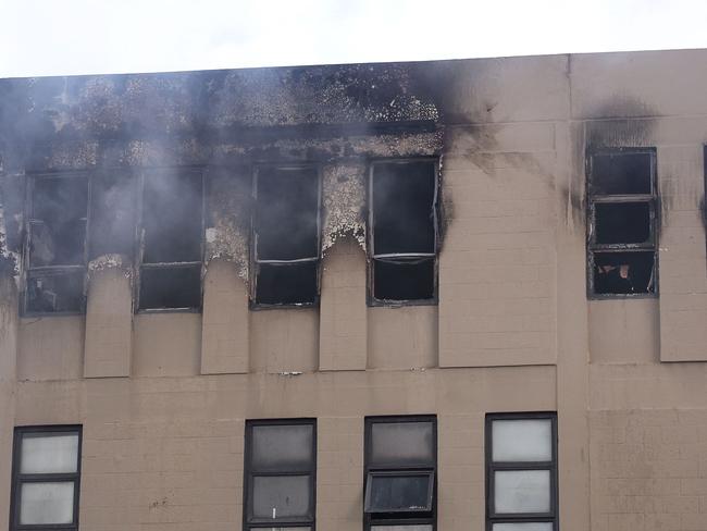 Damage is seen on the Loafers Lodge hostel building following a fatal fire. Picture: AFP