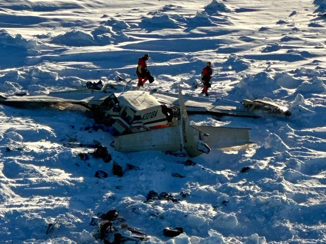 This image obtained from the US Coast Guard (USCG) on February 7, 2025, shows the remains of a plane reported missing February 6. The Bering Air Caravan was carrying nine passengers and one pilot on board. The search ended after the aircraft was located some 34 miles (55kms) southeast of Nome, Alaska. The USCG reported the three individuals were found inside and were deceased. "The remaining 7 people are believed to be inside the aircraft but are currently inaccessible due to the condition of the plane," according to a statement posted on the X of the USCG. (Photo by Handout / US Coast Guard / AFP) / RESTRICTED TO EDITORIAL USE - MANDATORY CREDIT "AFP PHOTO / US Coast Guard" - NO MARKETING NO ADVERTISING CAMPAIGNS - DISTRIBUTED AS A SERVICE TO CLIENTS