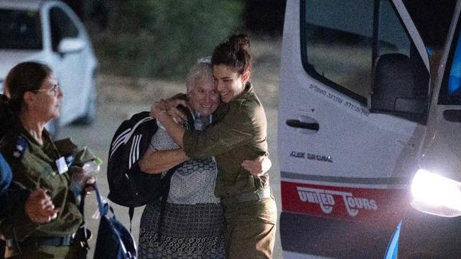 An Israeli soldier embraces former captive Margalit Moses upon her arrival in Israel, following her release by Hamas with 23 other hostages on Friday. Picture: AFP/ Israeli Army