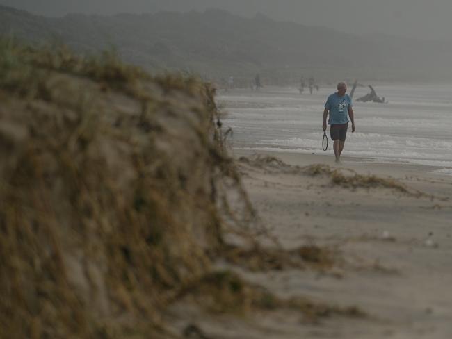 A man walks along 7 Mile Beach in Lennox Head on Thursday. Picture: NewsWire / Glenn Campbell