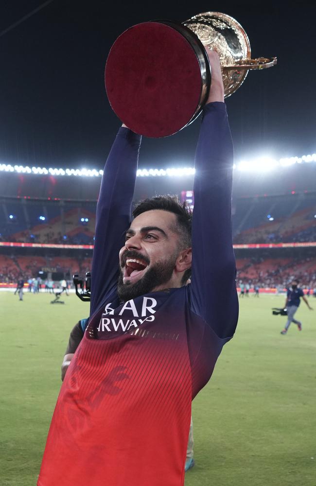 Royal Challengers Bengaluru's Virat Kohli celebrates with the winners trophy.