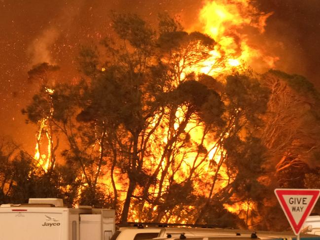 Bushfire arrives into the township of Malua Bay NSW, just south of Batemans Bay. Fires burning next to the beach on NYE.  Picture: Alex Coppel.