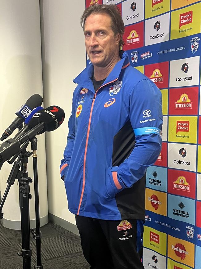 Luke Beveridge speaks with reporters after surgery to repair his broken hand