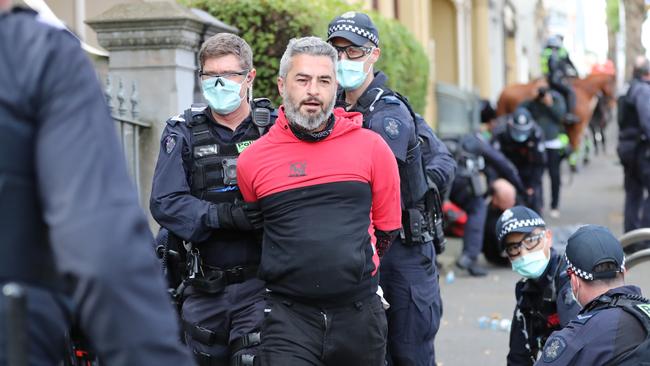 Police arrest a group in North Melbourne after they left the park. Picture: Alex Coppel