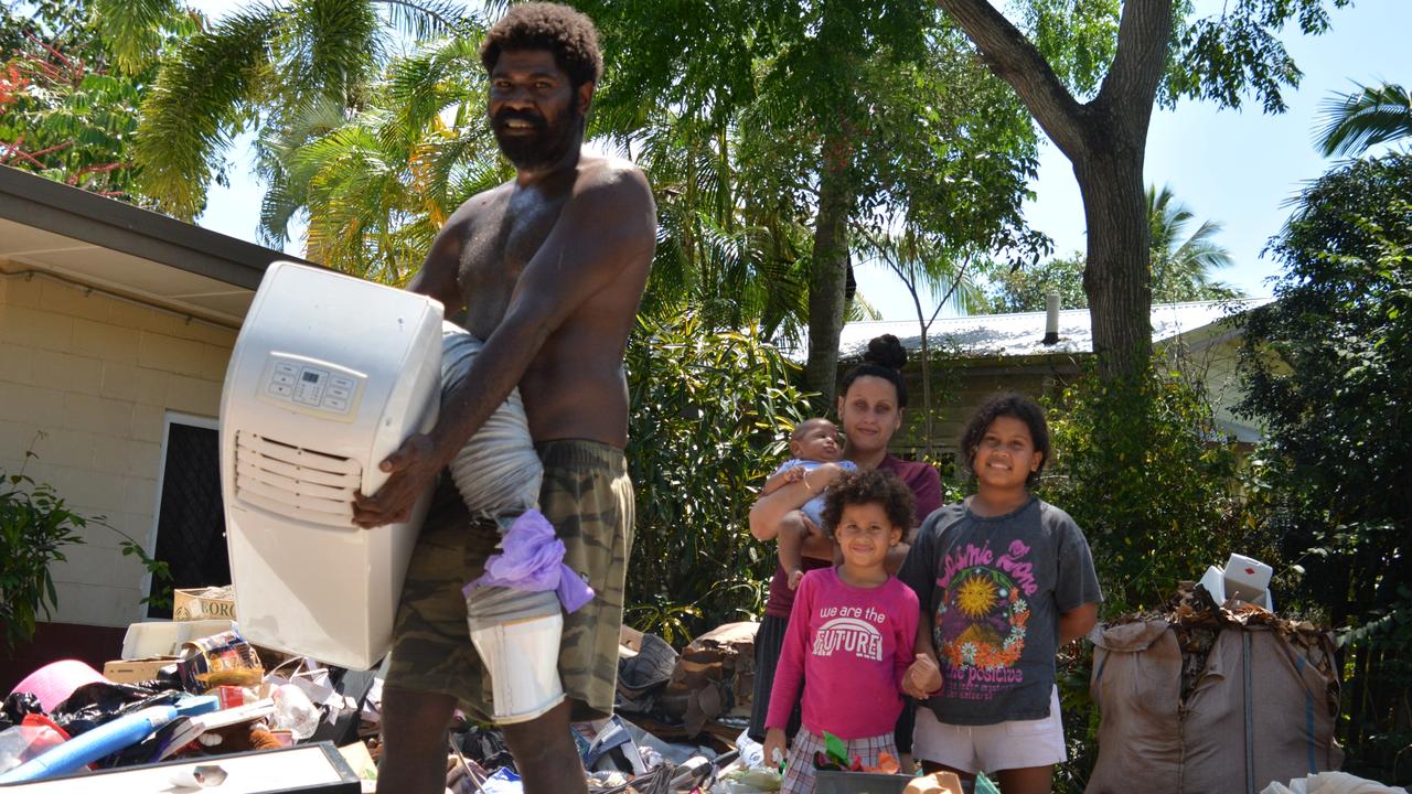 Michael Saveka and his partner Bonnie Short, with children Maria, Indie and baby Sam, were sorting through the destroyed contents of their Machans Beach home. Picture: Bronwyn Farr