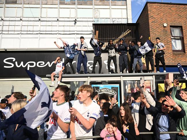 Fans of Tottenham Hotspurs clamber up for a better view of the parade. Picture: Getty Images