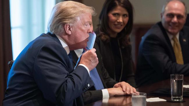Donald Trump kisses the proposed new tax form. Picture: AFP