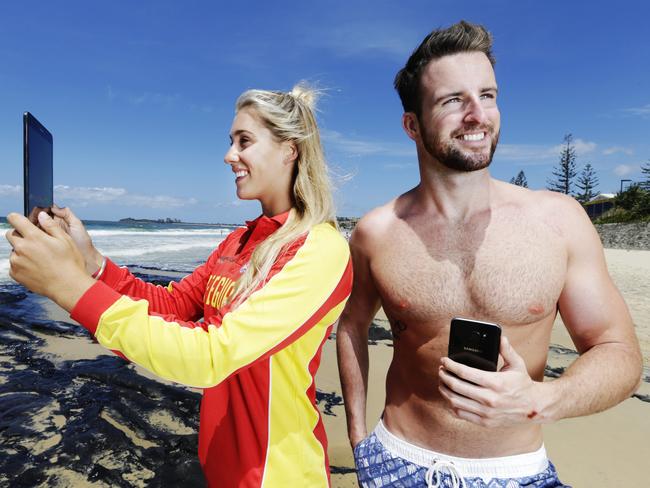 Alex Heads lifeguard Teisha Jenkins and Olympic swimmer James Magnussen trial the Samsung Pocket Patrol app on the Sunshine Coast. Picture: Lachie Millard