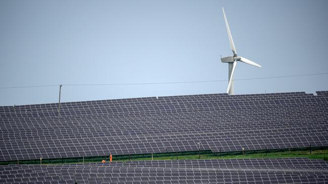 Wind turbines can be seen next to the Lightsource BP solar farm.