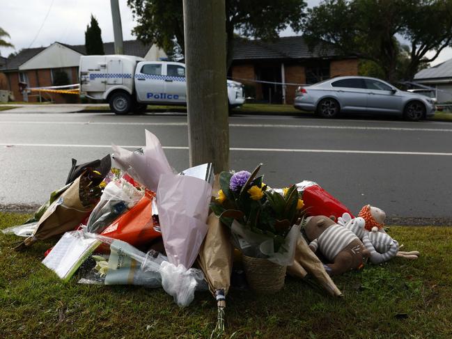 Flowers laid across the road from a house in Lalor Park where 3 children died in an alleged coward attack-related house fire. Picture: Richard Dobson