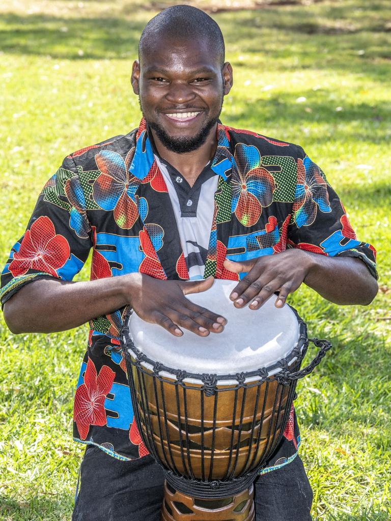 Pasaka Mwibusa tutors the drumming group. Harmony Day at Darling Heights State School assembly.