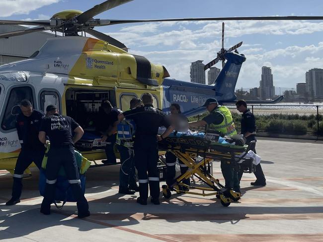 The injured primary-school aged child was transported from the scene of the crash by boat, before paramedics moved them to the waiting helicopter. Picture: RACQ LifeFlight