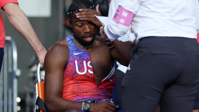 PARIS, FRANCE - AUGUST 08: Bronze medalist Noah Lyles of Team United States is taken off from the track with a wheelchair after competing in the Men's 200m Final on day thirteen of the Olympic Games Paris 2024 at Stade de France on August 08, 2024 in Paris, France. (Photo by Christian Petersen/Getty Images)