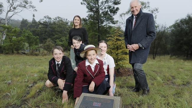 Dick Warner with his daughter Meg Bignell, and his grandchildren Edward Bignell, left, William Bradshaw, Lucie Bignell and Nell Bradshaw, at his great-uncle Archie  Flexmore’s tree on the Soldiers’ Memorial Avenue. Picture: MATHEW FARRELL