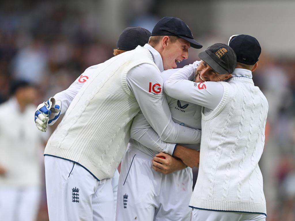 Joe Root is mobbed by his England teammates after his stunning catch to remove Marnus Labuschagne on day two. (Photo by Gareth Copley/Getty Images)