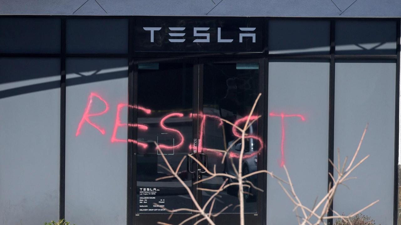 The word "RESIST" is spray painted on the entrance of a Tesla Collision Center after a person used incendiary devices to set several vehicles on fire on March 18, 2025 in Las Vegas, Nevada. Picture: Ethan Miller/Getty/AFP