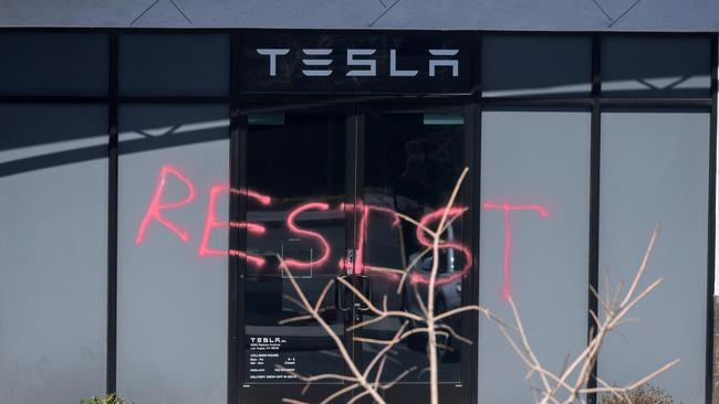 The word "RESIST" is spray painted on the entrance of a Tesla Collision Center after a person used incendiary devices to set several vehicles on fire on March 18, 2025 in Las Vegas, Nevada. Picture: Ethan Miller/Getty/AFP