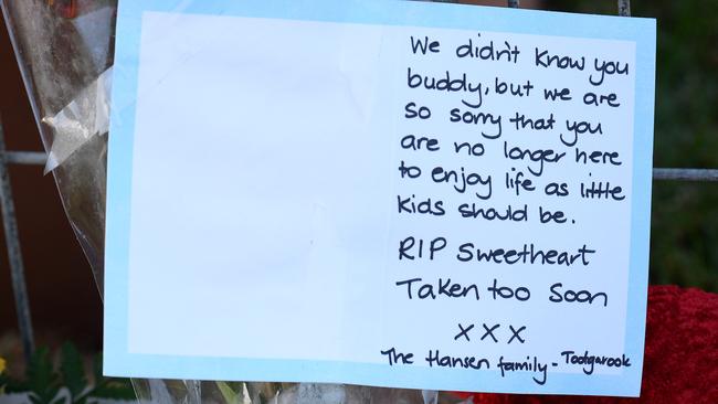 Flowers and toys adorn the front fence of the home. Picture: Lawrence Pinder