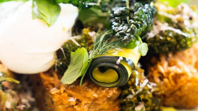 Fried broccoli, zuni pickles, green goddess, leek and chive hash, anchoiade, pecorino, poached eggs and fresh garden herbs at Two Blocks cafe. Picture: Supplied.