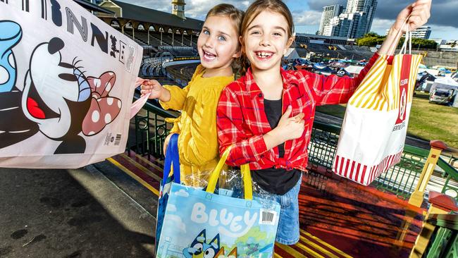 Seven-year-old Peggy Mackenzie and eight-year-old Esther McKeering at Brisbane Showgrounds with showbags for EKKA 2021. Picture: Richard Walker