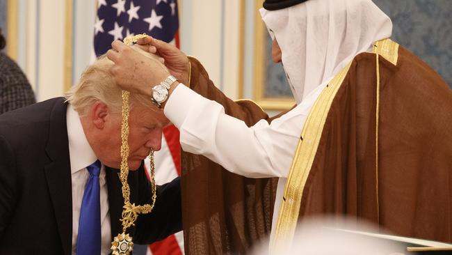 Saudi King Salman presents President Donald Trump with the highest civilian honour, the Collar of Abdulaziz Al Saud, at the Royal Court Palace, in Riyadh in 2017. Picture: AP