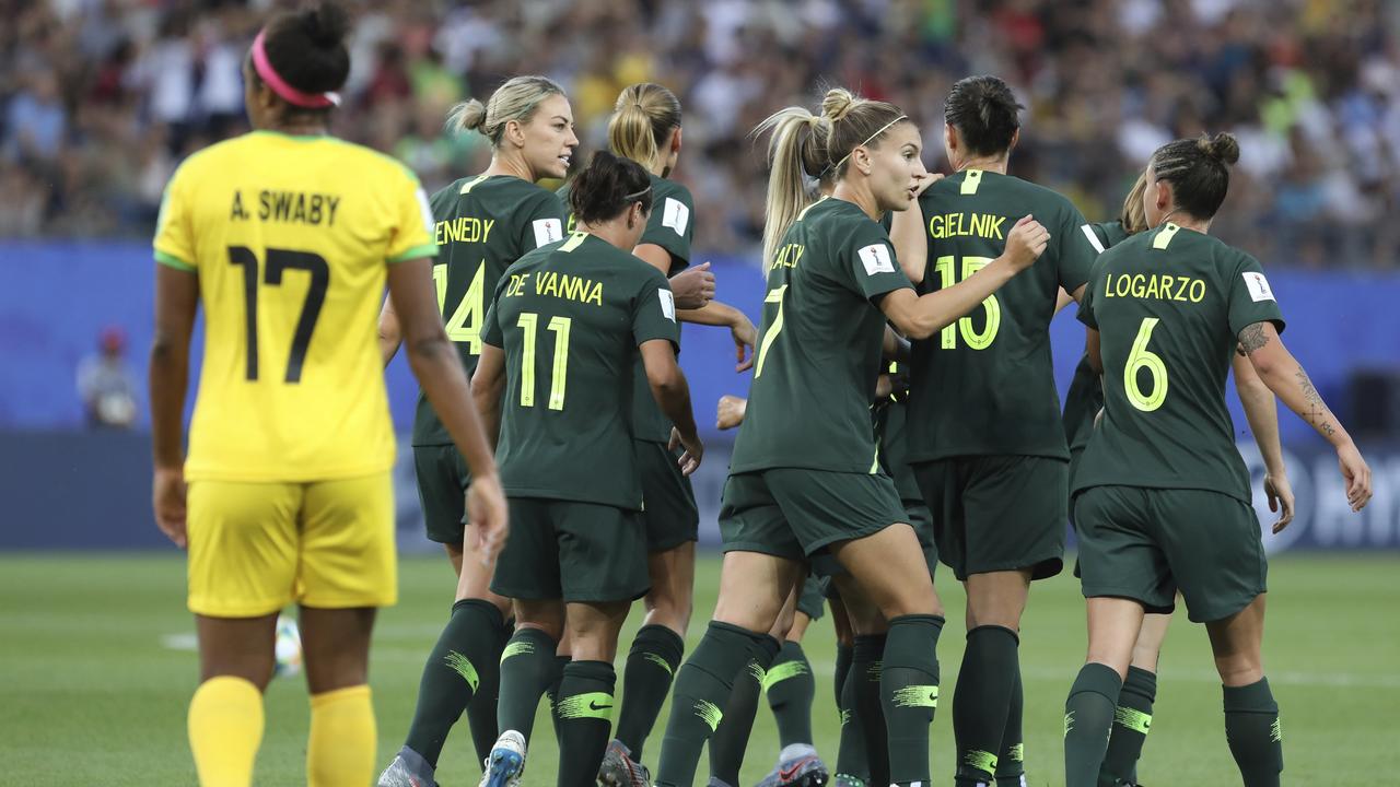 Australia's Sam Kerr is congratulated by her teammates after scoring the opening goal. (AP Photo/Laurent Cipriani)
